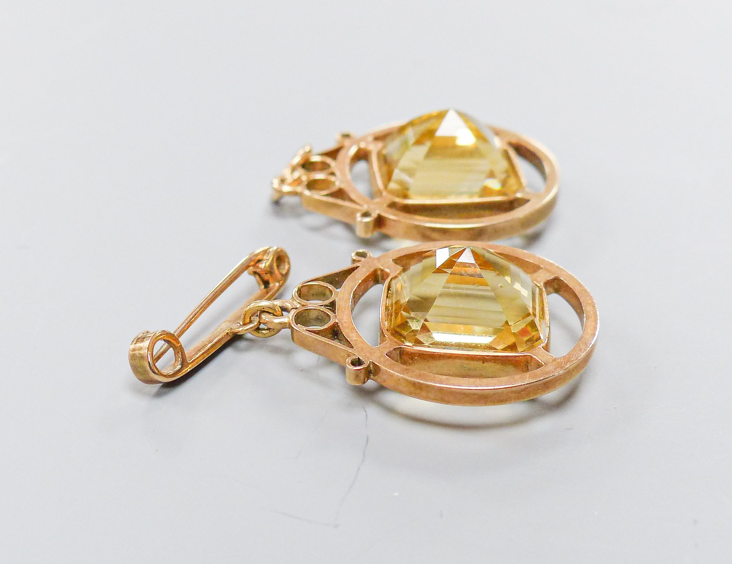 A 9ct mounted step-cut octagonal citrine pendant, 29mm and a matching brooch with suspension pin, gross weight 15.4 grams